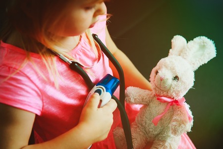 little girl play doctor or nurse with toyの写真素材