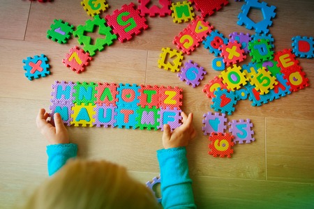 little girl playing with puzzle, early educationの写真素材