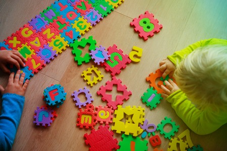 kids playing with numbers and letters puzzle, education conceptの写真素材