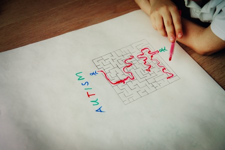 autims awareness- child solving labyrinth, mental health careの写真素材