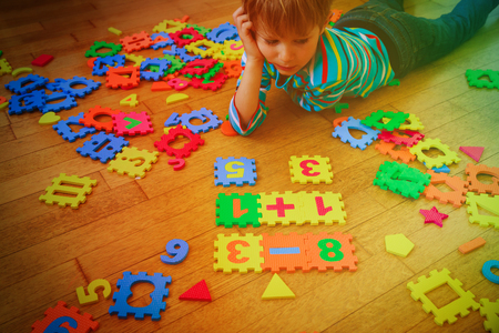 little boy playing with puzzle, education conceptの写真素材
