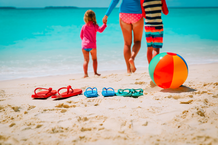 mother with son and daughter walking at beachの写真素材
