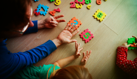 teacher and kids play with number puzzleの写真素材