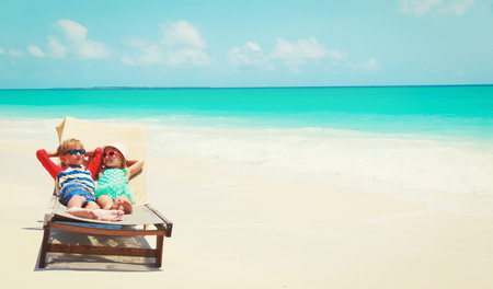 happy little boy and girl relaxed on summer beachの写真素材