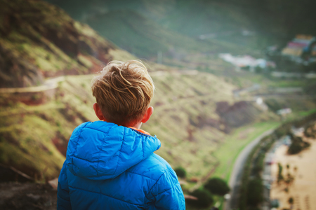 little boy looking at scenic view while travelの写真素材