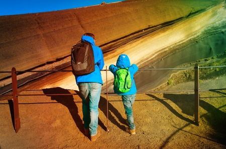 father and son looking at lava in Teide volcano, Tenerifeの写真素材