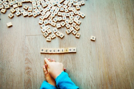 education and learning - child play with letter puzzleの写真素材