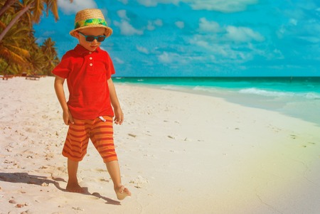 little boy walk on tropical beachの写真素材