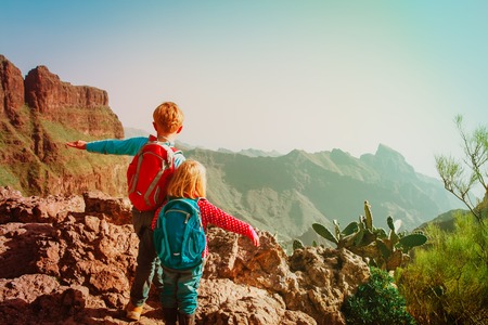 happy little boy and girl travel in mountainsの写真素材