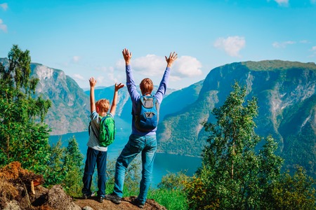 happy father and son hiking travel in mountains, Norwayの写真素材