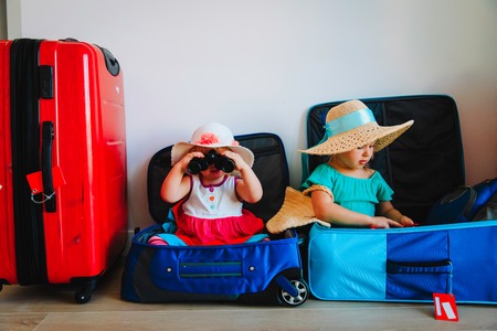little girls enjoy packing and travel, family going on vacationの写真素材