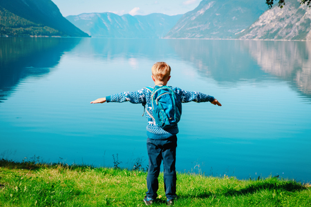 happy little boy travel hiking in scenic natureの写真素材