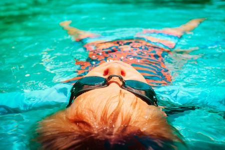 little boy relax in water on beach, vacation conceptの写真素材