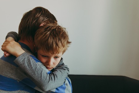 Father comforting sad child, parenting, sorrowの写真素材