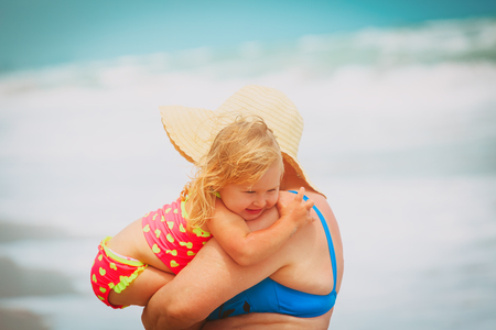 little granddaughter hug grandmother on beachの写真素材