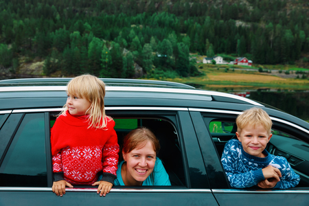 happy family- mother with son and daughter- travel by carの写真素材