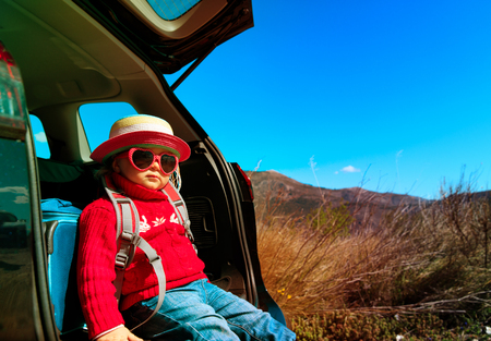 cute little baby girl travel by car in natureの写真素材