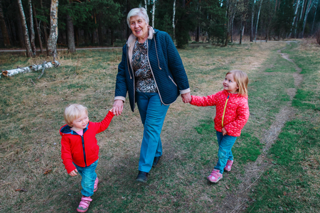 grandmother with kids walk in natureの写真素材