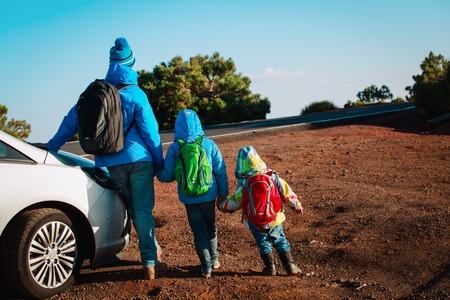 father with son and daugther travel by car in natureの写真素材