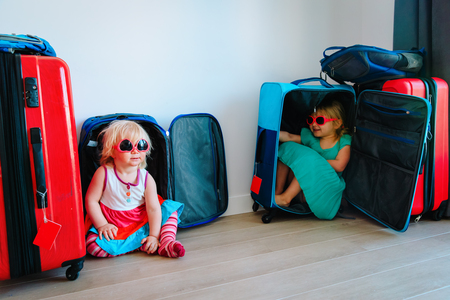 little girls enjoy packing and travel, family going on vacationの写真素材