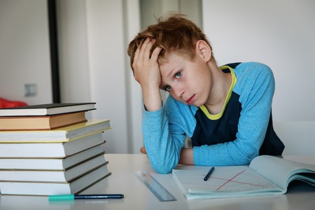 little boy tired of doing homeworkの写真素材