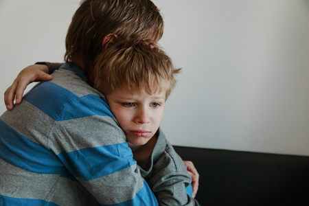 Father comforting sad child, parenting, sorrowの写真素材