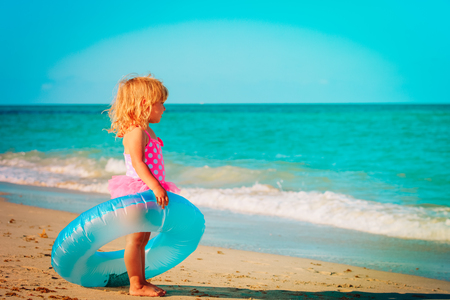 cute little girl with tube go swim at tropical beachの写真素材