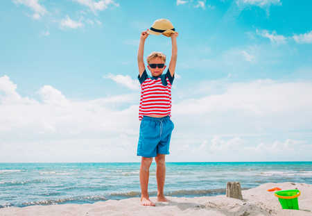 happy boy hands up enjoy tropical beachの写真素材