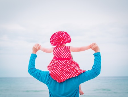 father and little daughter play at skyの写真素材