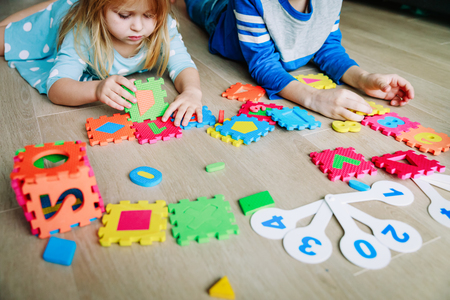 kids learning numbers, calculations, play with puzzleの写真素材