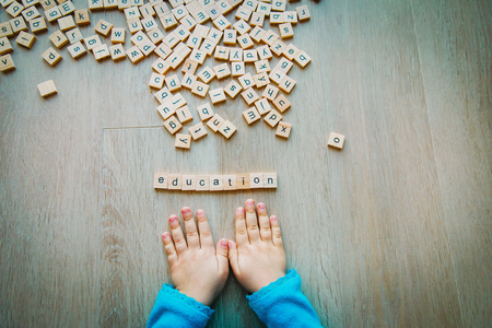little girl play with letter puzzle in school or daycareの写真素材