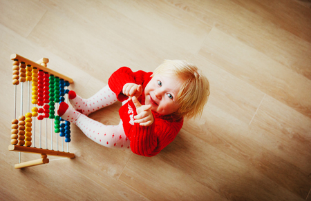 little girl playing with abacus, learning mathの写真素材