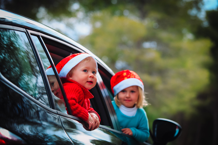 christmas car travel- happy kids travel in winterの写真素材