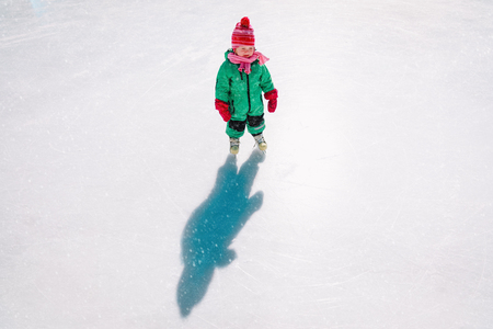 little girl learn to skate in winterの写真素材