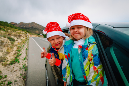 christmas car travel- happy kids travel in winterの写真素材
