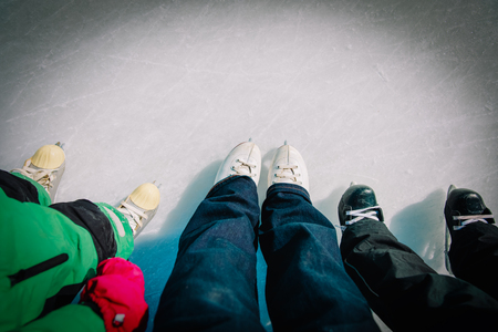 mother and kids skating together in winterの写真素材