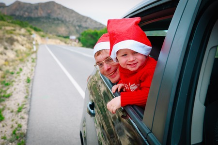 christmas family car travel- happy little girl with dad travel in winterの写真素材
