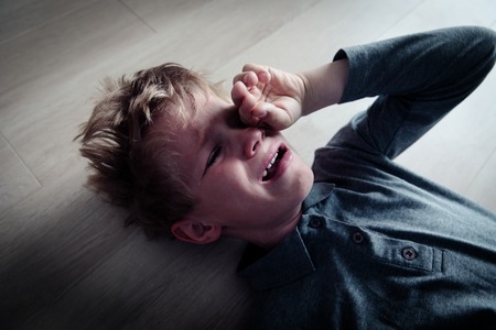 crying stressed tired exhausted child, overload, abuseの写真素材