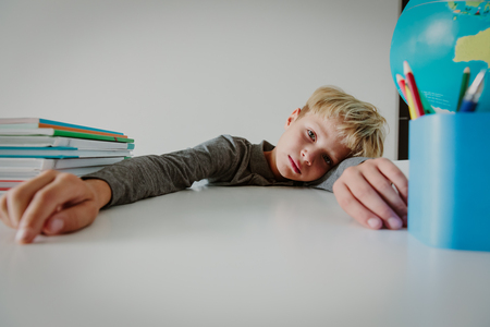 young boy cry tired of doing homework, overload, stressの写真素材