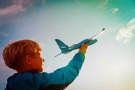 young boy play with toy play at sky