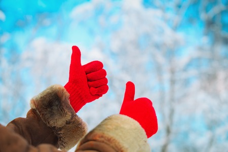 love winter concept- thumb up in snow natureの写真素材