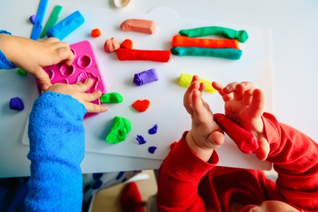 kids play with clay molding shapes, learning through play