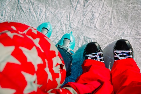 father and child learning to skate in winterの写真素材