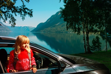 happy little girl enjoy travel by car in nature, family transportの写真素材