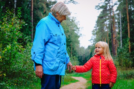 grandmother with granddaughter walk in nature