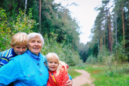 happy grandmother and grandkids enjoy being together in natureの写真素材