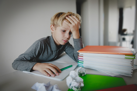 little boy tired stressed of reading, doing homeworkの写真素材