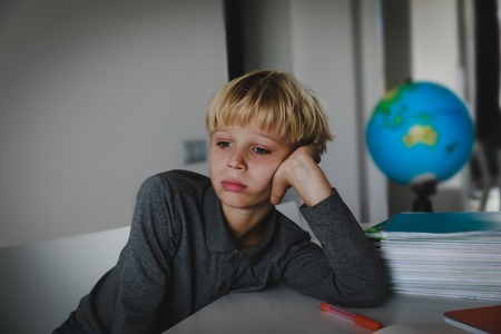 little boy tired stressed of reading, doing homeworkの写真素材