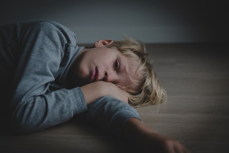 sad stressed tired exhausted child at homeの写真素材