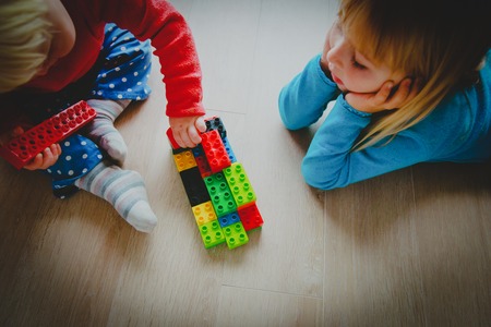 kids play with plastic blocks, learning concept